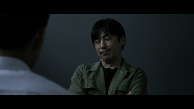 Man interrogating in dark room
