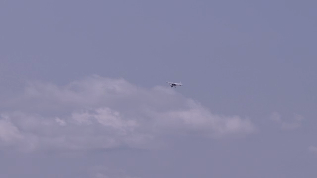 A small airplane flying over mountains