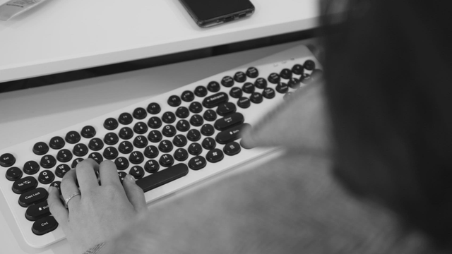 Hands on a keyboard in an office