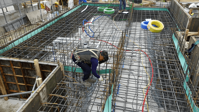 Construction worker welding rebar