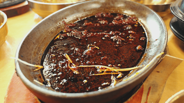 Leftover soy-based sauce in a table bowl