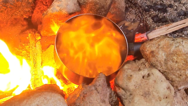 Cooking over an open fire with rocks