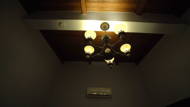 Ceiling with a chandelier and air conditioner