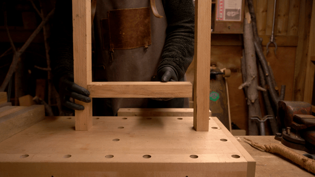 Carpenter positioning wooden pieces for assembly