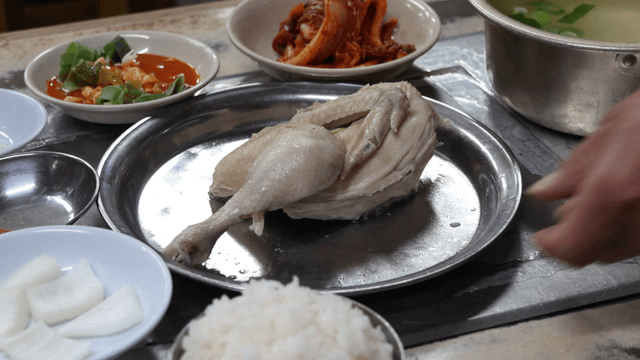 Chicken soup meal served with side dishes