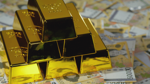 Gold bars stacked on Korean currency