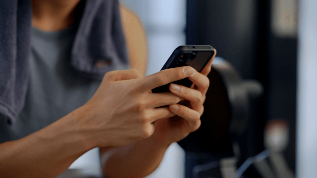Man using a smartphone in a gym