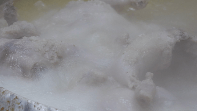 Boiling chicken in a pot