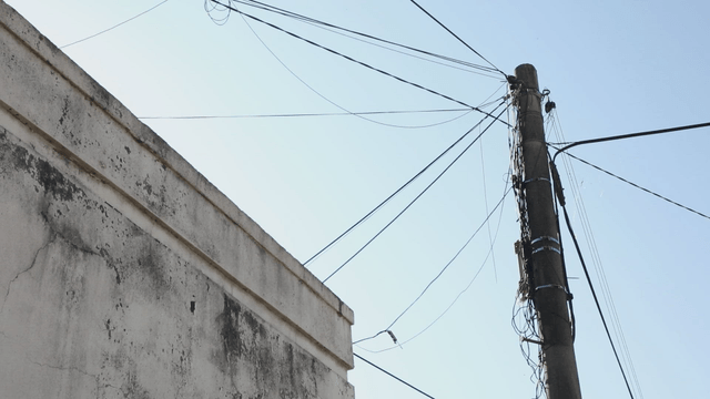 Electric pole and building under clear sky