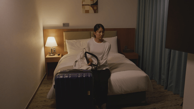 Woman arriving at a cozy hotel room