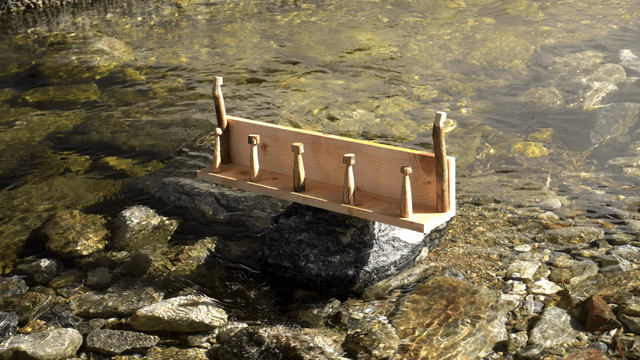 Wooden shelf placed on rocks above a clear stream