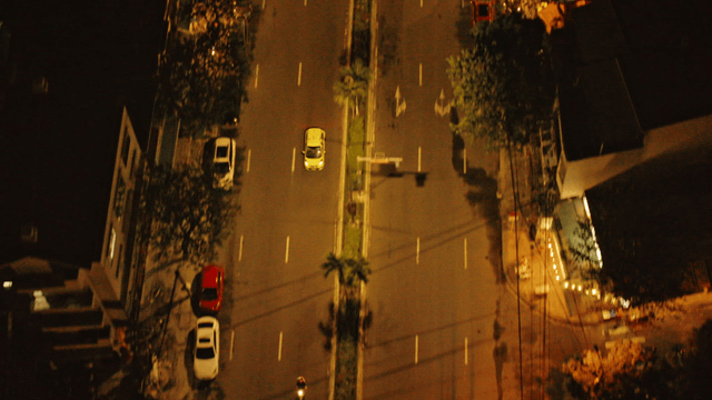 Nighttime street with moving cars