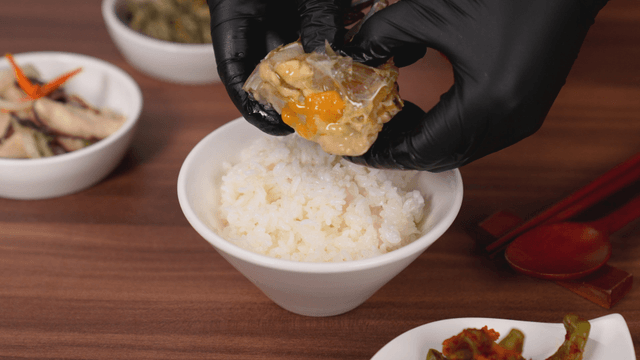 Rice with marinated crab being prepared