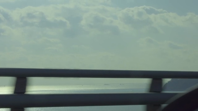 Car driving on a bridge over the sea