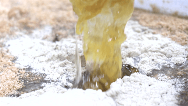 Powder and liquid seasonings mixed in large bowl