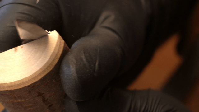 Carving a piece of wood with a knife