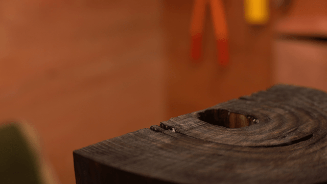 Smoke rising from the surface of a wooden sculpture