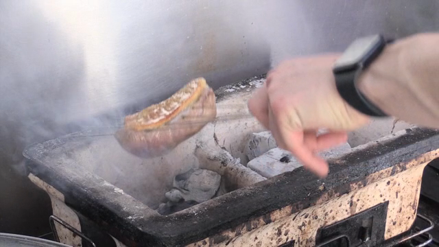 Juicy duck meat grilling on a rack