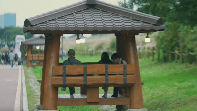 People sitting in a park gazebo
