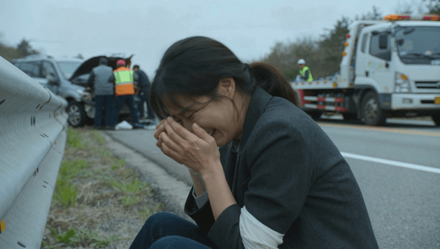 Woman crying by a car accident scene