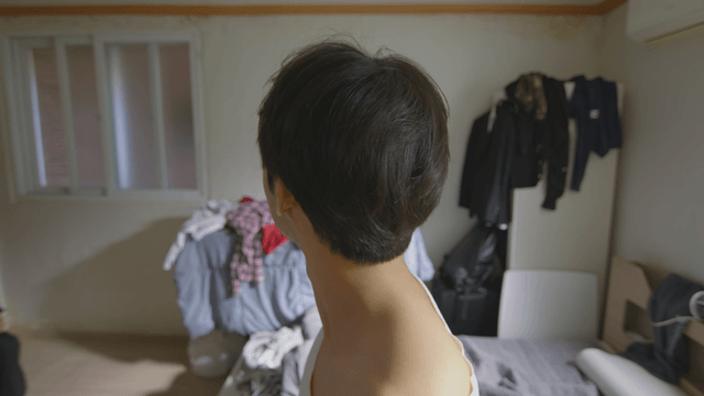 Man catching a bug in a messy room
