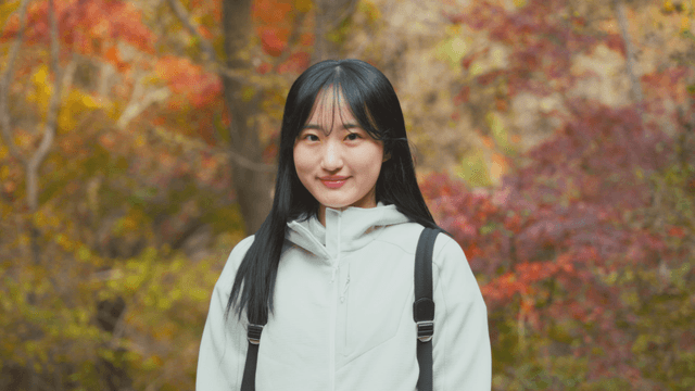 Young woman in colorful autumn forest