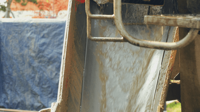Concrete pouring from a mixer at a site