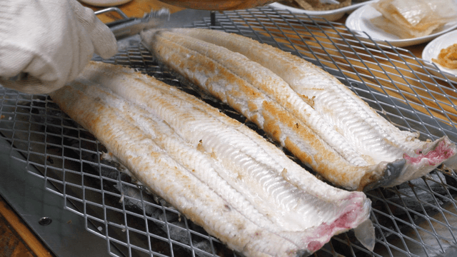 Eels grilling on barbecue grill