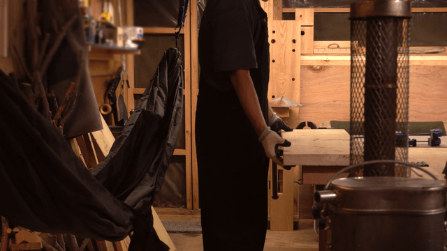 A person working with wood in a workshop