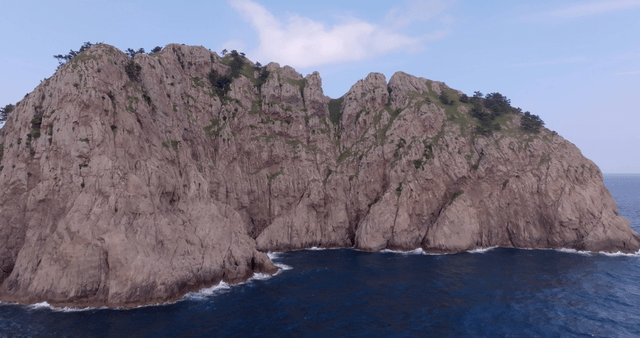 Rocky cliffs by the ocean with waves
