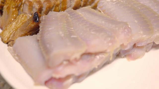 Sliced pork and raw skate on a plate