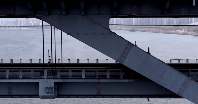 View of a bridge over a river with cityscape