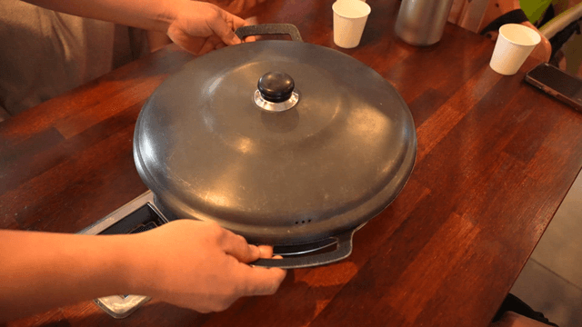 Large pot set on gas stove over restaurant table