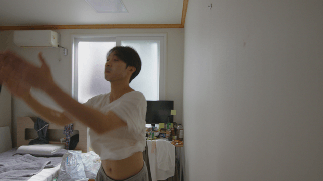 Man catching a bug in a messy room