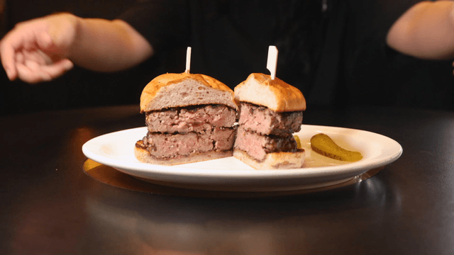 Burger on plate being handed over to staff