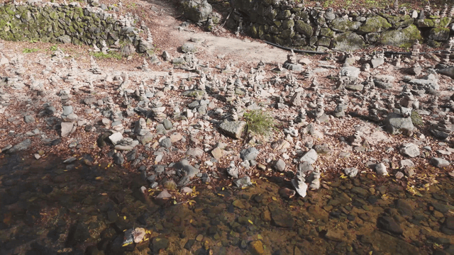 Quiet stream filled with stacked stone towers