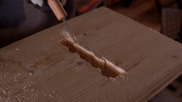 Wood being cut with a hand saw