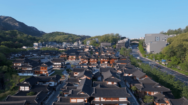 Traditional hanok village with mountain backdrop