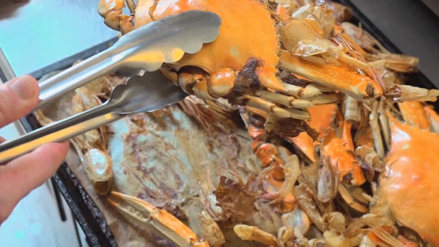 Crabs and shrimp shells on a tray in a kitchen
