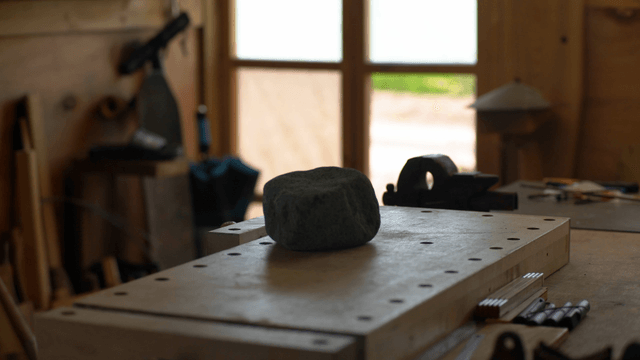 Workshop with tools and a stone on a table