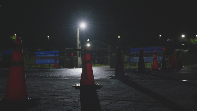 Night road with traffic cones and streetlights