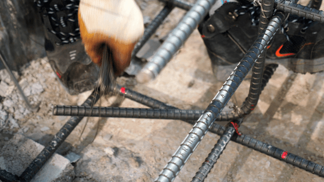 Worker tying rebar at a construction site