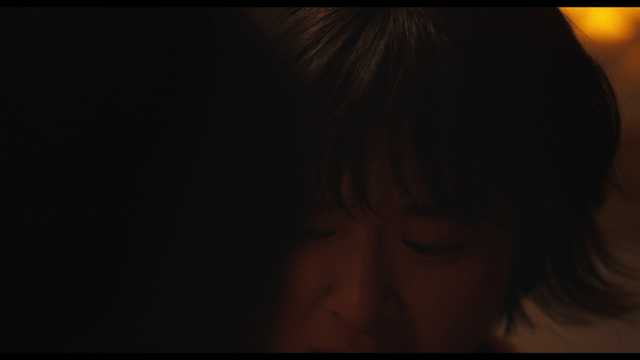 Woman looking worried in dim light