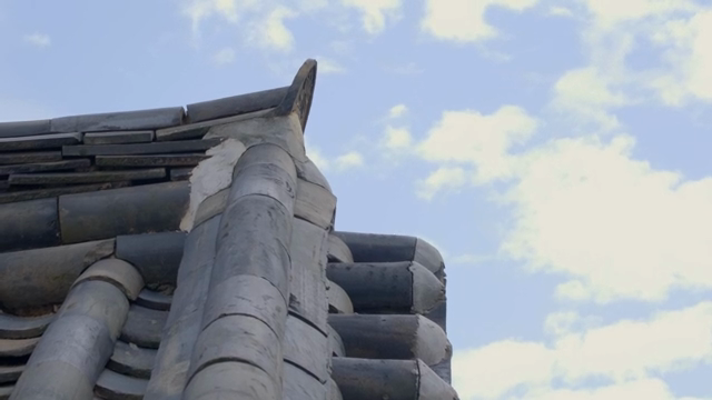 Traditional Korean roof against blue sky