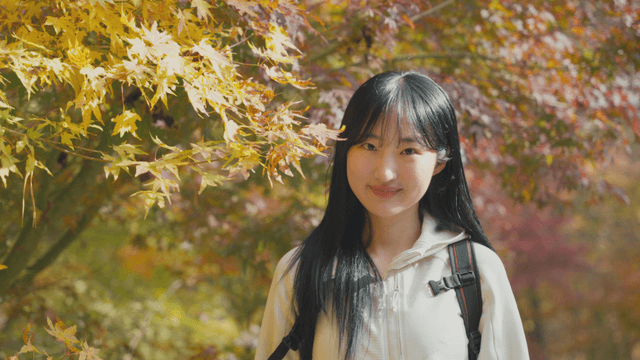 Woman enjoying autumn foliage on mountain trail