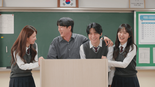 Students and teacher laughing in classroom