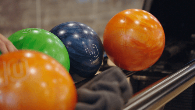 Selecting a bowling ball from the rack
