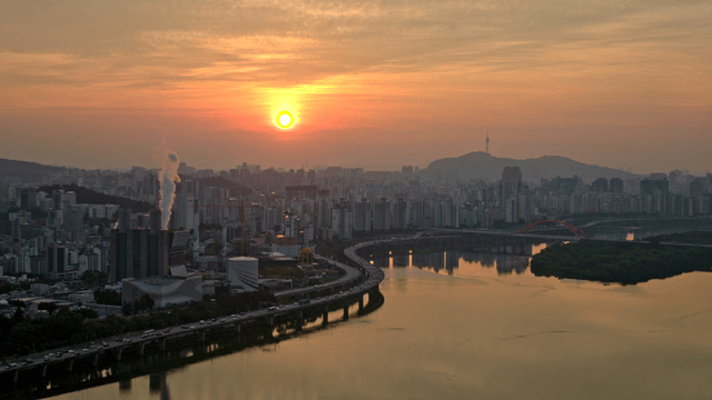 Sunset over a bustling city skyline