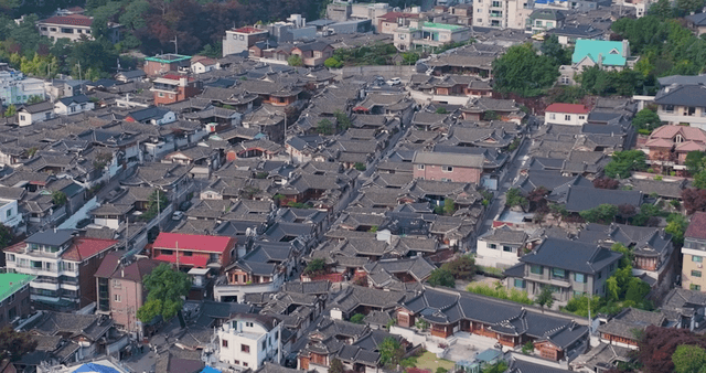 Panoramic view of a Hanok village lined with traditional tiled roofs