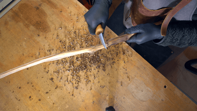 Person carving a wooden stick